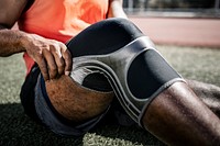 Athlete putting on a kneepad