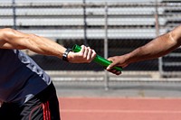 Team mates passing a relay baton 