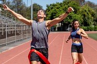 Man runner winnning with arms open, athletic race competition