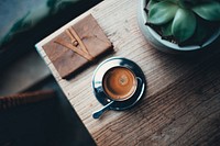 Free black coffee cup and note book on wooden table top view public domain CC0 photo.