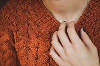 Free woman hand on orange sweater image, public domain people CC0 photo.