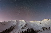 Free snowy mountain under starry sky public domain CC0 photo.