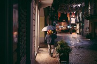 Free man with umbrella & flower walking alone image, public domain human CC0 photo.