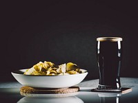 Free stout beer with chips bowl photo, public domain beverage CC0 image.