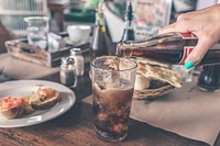 Free pouring cola at dining table in restaurant public domain CC0 photo.