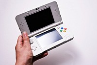 Nintendo 3DS in woman's hand, location unknown, date unknown.