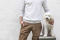 Free man posing with white fluffy dog image, public domain animal CC0 photo.