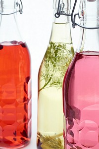 Free infused herbs glass bottle photo, public domain beverage CC0 image.