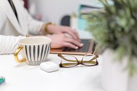 Free cup, glasses, and a woman working photo, public domain work CC0 image.