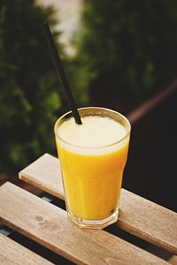 Free orange smoothie on wooden table photo, public domain beverage CC0 image.