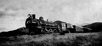 Steam train in a open countryside.