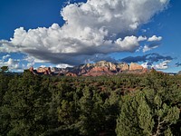 At least thirteen named canyons and numerous buttes and mountains surround the Arizona city of Sedona, and many of those formations take on spectacular hues when the sun fully strikes them.