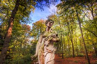 Sculpture of a women amongst trees, free public domain CC0 photo