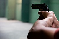 Free person aiming with pistol photo, public domain weapon CC0 image.