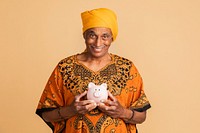 Happy mixed Indian man holding a piggy bank 