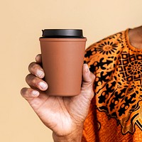 Indian man holding a tumbler