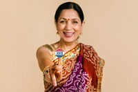 Indian woman showing a vote sticker