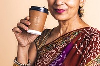 Indian woman in a saree drinking coffee from a paper cup mockup 