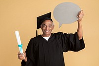 Proud senior man in a graduation gown holding a speech bubble mockup 