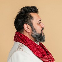 Indian man wearing a kurta with a red scarf side profile shot
