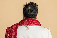 Rear view of an Indian man wearing a kurta with a red scarf