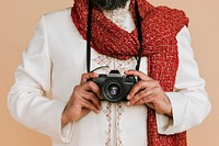 Indian man in a kurta with a digital camera 