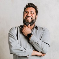 Cheerful Indian man thinking with his hand on the chin 