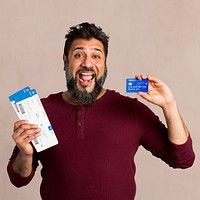 Excited Indian man holding a credit card and fligh tickets mockup 