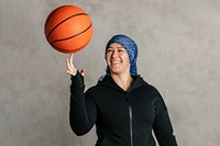 Islamic woman spinning a basketball on her finger