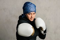 Young Islamic woman wearing a sport hijab while boxing 