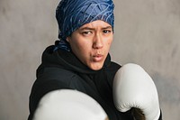 Young Islamic woman wearing a bandana while boxing