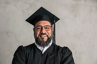 Proud senior man in a graduation gown 