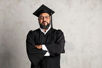 Proud senior man in a graduation gown 