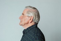 Senior man wearing a tartan shirt in profile shot 