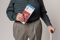 Senior man traveling with his passport and luggage 
