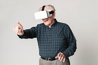 Cheerful senior man wearing virtual reality goggles