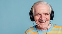 Happy senior man listening to music with headphones