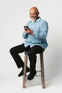 Happy retired man using a smartphone