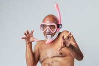 Funny senior African American man wearing a pink snorkel and goggles