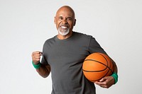 Happy senior man holding a basketball