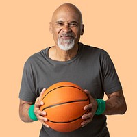 Happy senior man holding a basketball mockup 