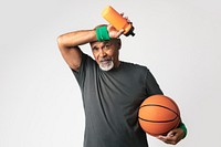 Sweaty senior coach holding a basketball 