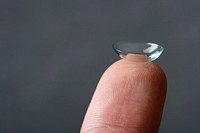 Lens on finger, free public domain CC0 image.