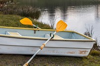 Free rowboat on the shore of a river image, public domain CC0 photo.