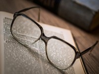 Free glasses on open book photo, public domain CC0 image.