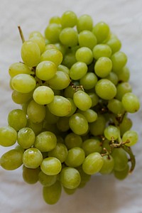 Bunch of green grapes on a white cloth