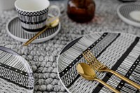 Modern black patterned tableware with gold cutlery