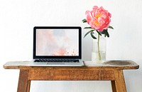 Blank laptop screen mockup by a pink peony