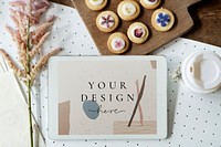 Tablet screen mockup and cookies on a wooden board