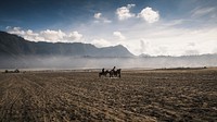 Nature desktop wallpaper background, horseback riding at Mount Bromo, Indonesia